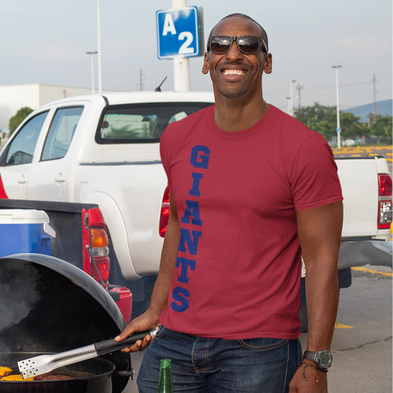 A man at a tailgate wearing a Men’s NFL Game Day T-Shirt – handcrafted with aloha, GIANTS fan – Simply Aloha On The Go
