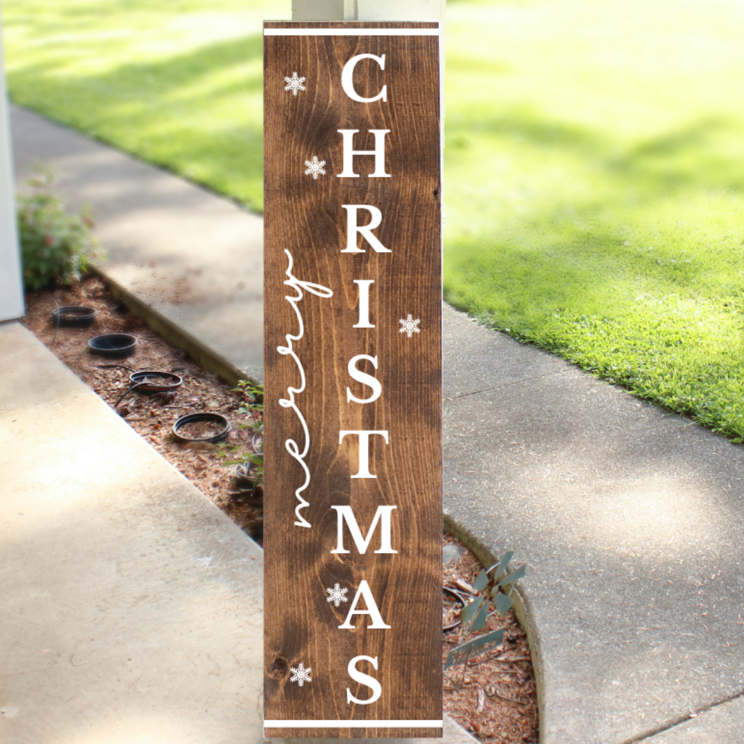 Vertical stained wood Christmas porch sign readingMerry Christmas with white lettering and snowflake accents, handcrafted by Simply Aloha On The Go