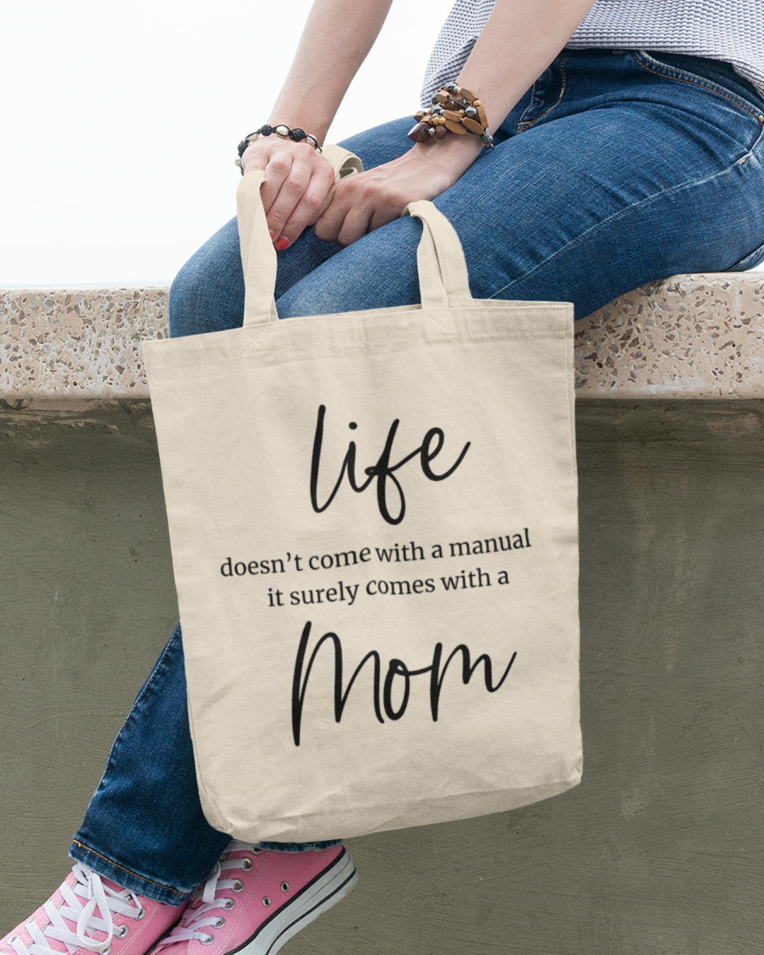 Mom's canvas tote bag featuring text with  "life doesn't come with a manual, it surely comes with a mom" 