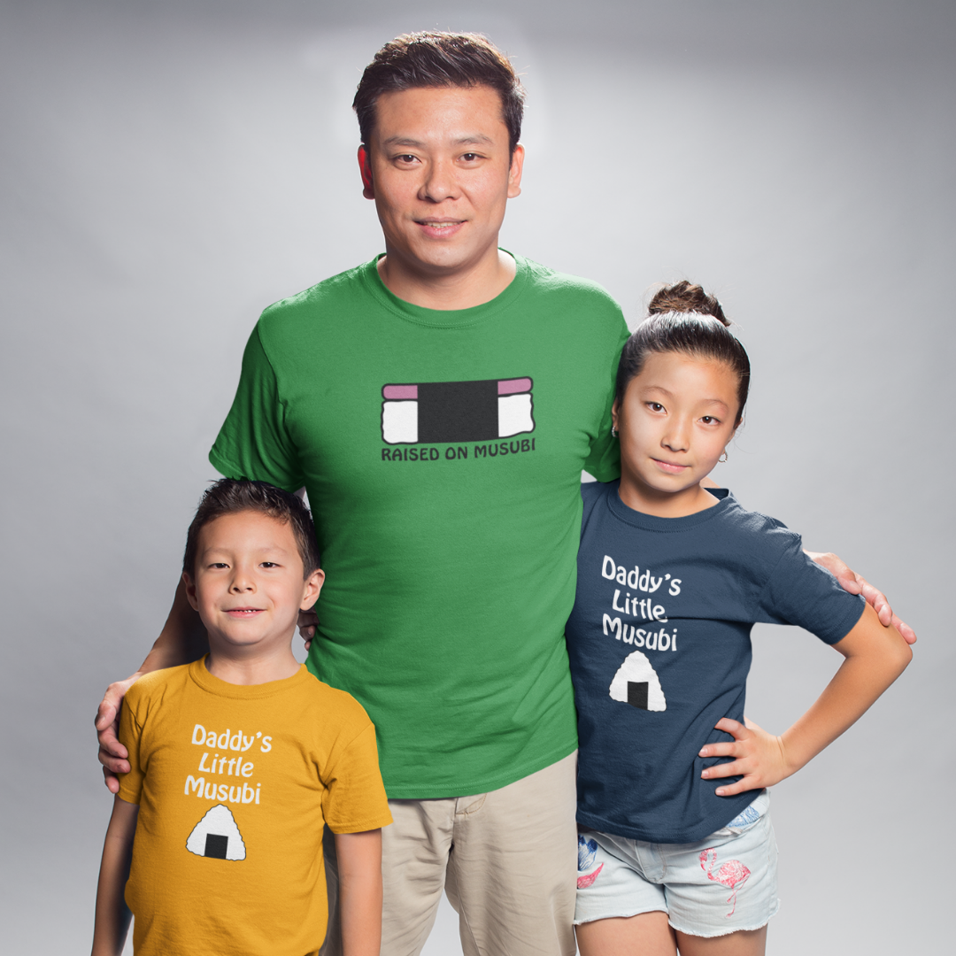 Father and two children wearing green, navy, and yellow matching Musubi family Hawaiian t-shirts.