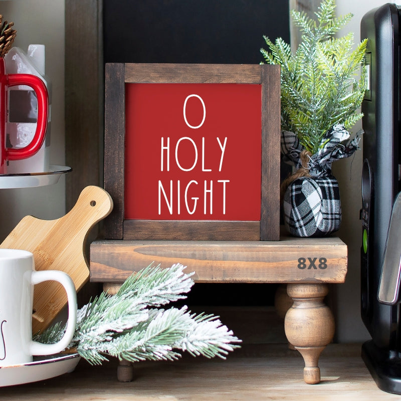 Red O Holy Night Christmas sign with white lettering in a stained wood frame on a farmhouse holiday display.