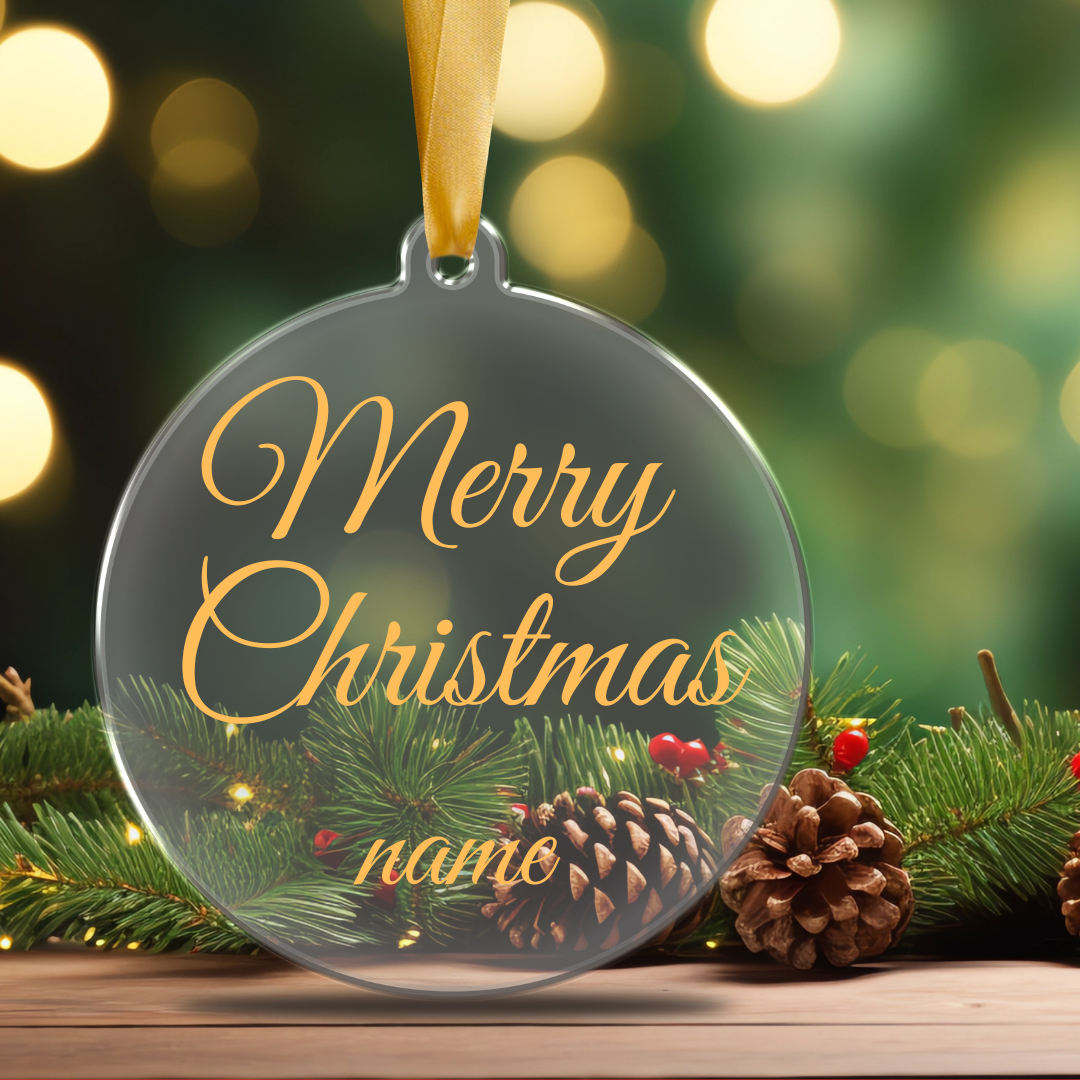 A clear, flat acrylic Merry Christmas ornament personalized with a name  in gold or white script font, hanging from a tree branch designed by Simply Aloha On The Go.