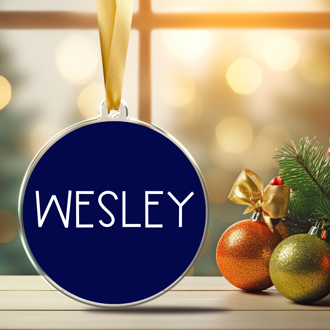 Personalized 3-inch clear acrylic with your name in print minimal font-ornament with permanent white vinyl lettering with a satin ribbon and navy blue background