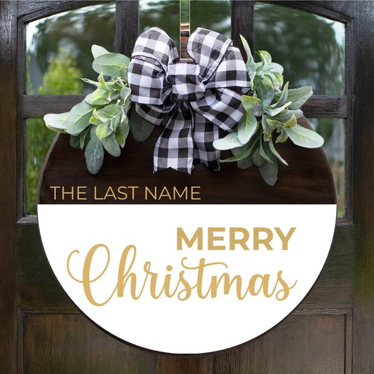 Custom round wooden Christmas door hanger with a gold Merry Christmas script, personalized family name