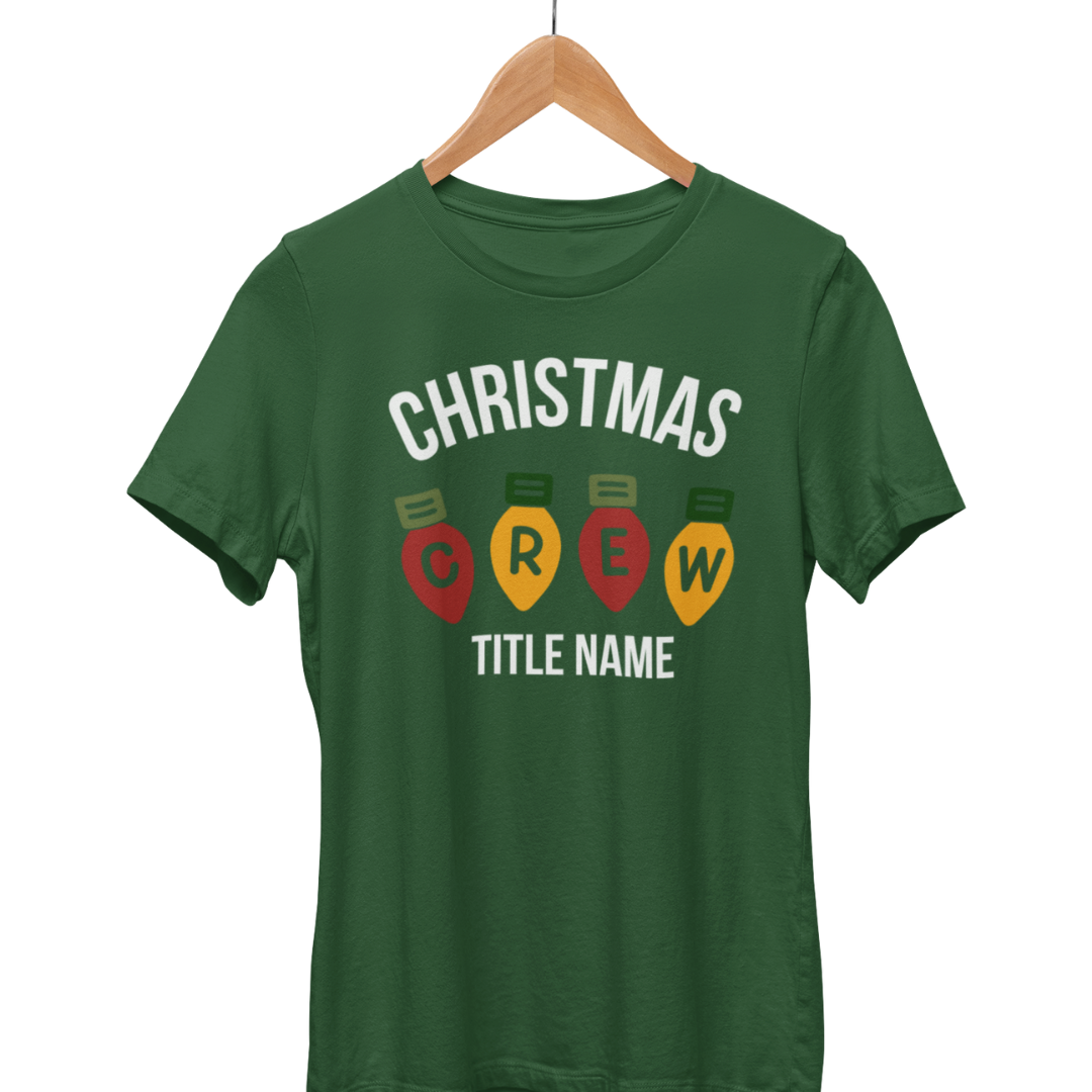 Green adult Personalized Christmas Family T-shirt on a hanger with Christmas Crew lettering and a name placeholder.