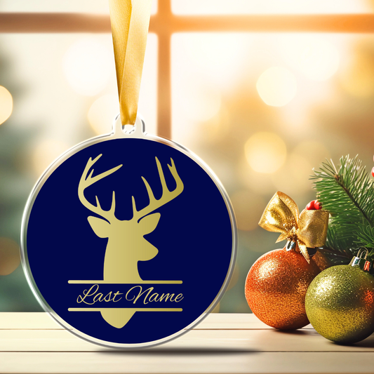 Personalized Deer Christmas Ornament with gold deer silhouette, Last Name lettering, navy blue background and gold satin hanging ribbon.