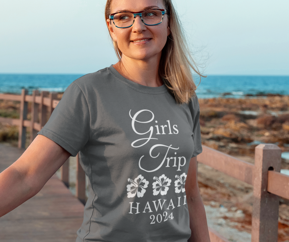 A teen wearing a personalized "Girls Trip" t-shirts on vacation