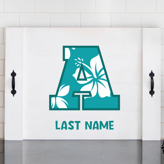 Custom Hawaiian noodle board with family initial and last name, featuring a vibrant hibiscus flower design – personalized kitchen decor with island vibe.