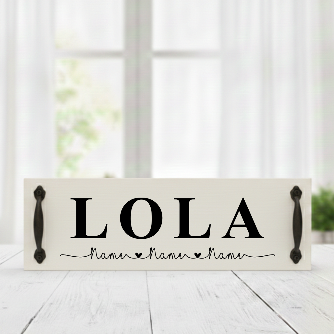 Wooden sign with "LOLA" and decorative text on a white surface
