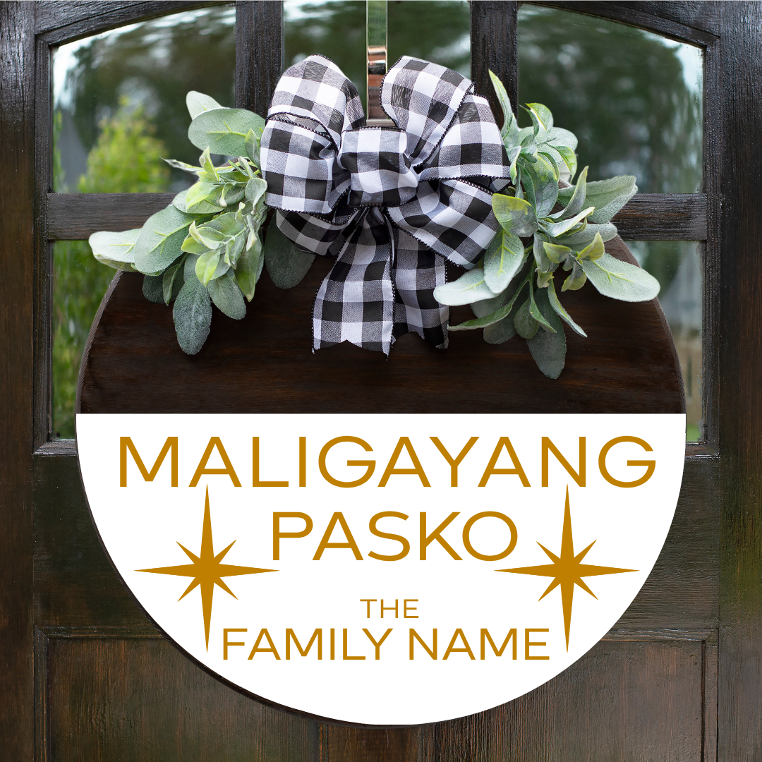 Personalized round Christmas door hanger with "Maligayang Pasko" and custom family name in gold font on a white stained background