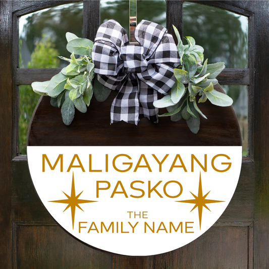 Personalized round Filipino Christmas door hanger with "Maligayang Pasko" and custom family name in gold font on a white stained background