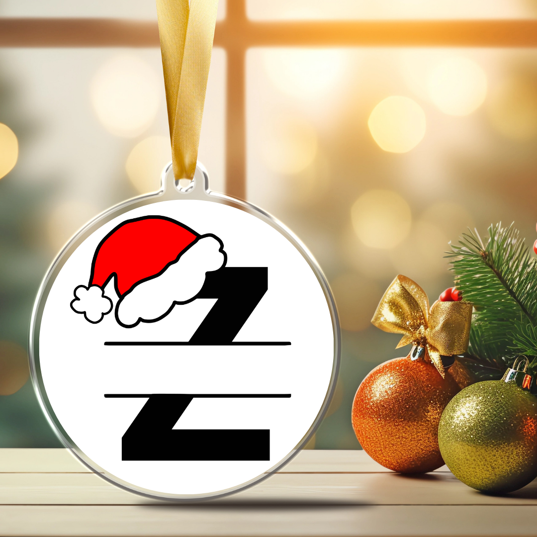 Personalized monogram Christmas ornament featuring black letter Z with a red Santa hat, blank center banner for a custom name or title, and gold satin ribbon.