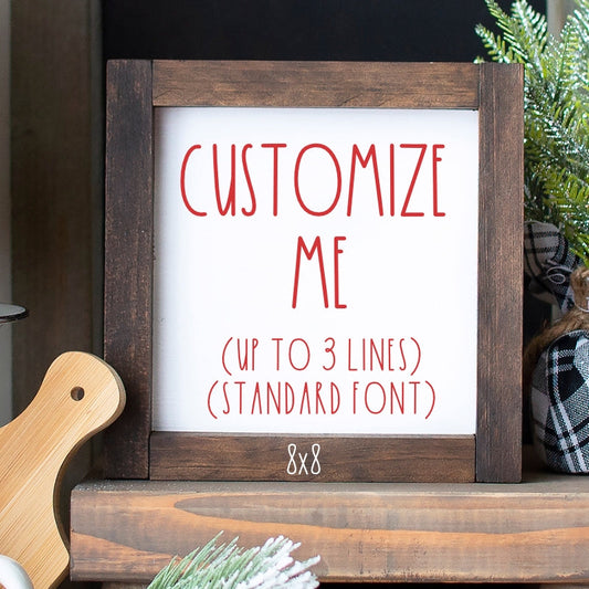 Personalized shelf sitter sign with white background, red custom text example and rustic wood frame.