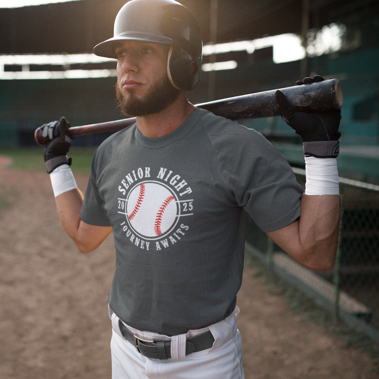 Front view of a custom baseball and softball senior night t-shirt for high school athletes. Features a graphic representing the sport, the year 2025, and the text "Senior Night: The Journey Awaits." The shirt is available in black and grey.
