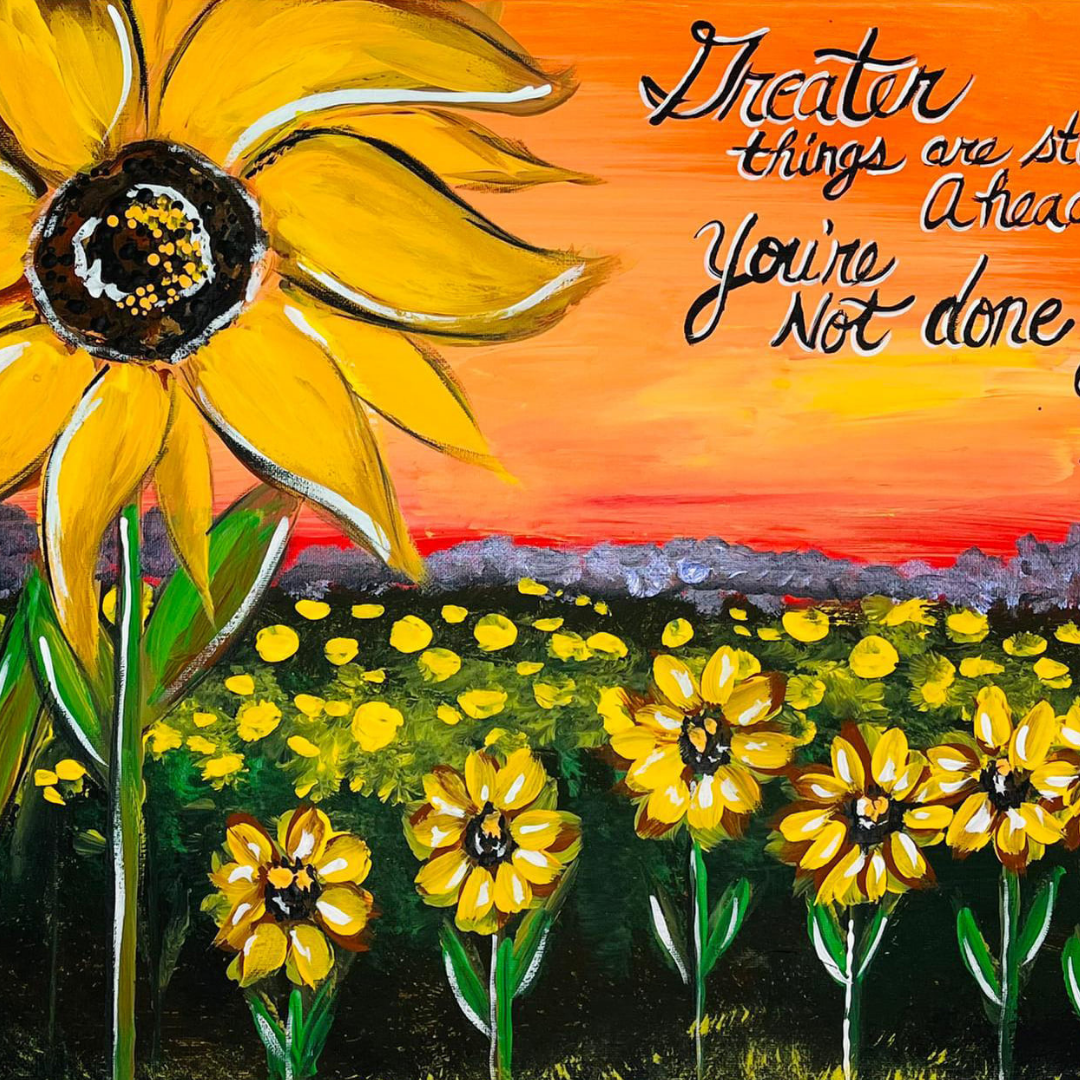 An overhead view of various summer-themed DIY canvas paintings including a painting of a sunflower field 