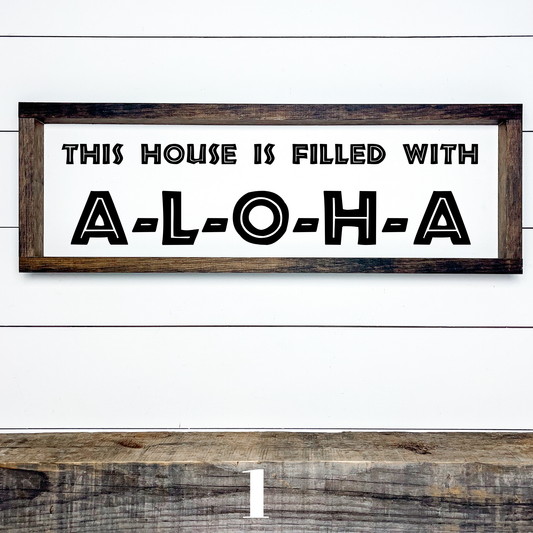 Horizontal wood sign with text "This House is Filled with Aloha" in multiple font styles, handcrafted by Simply Aloha On The Go.