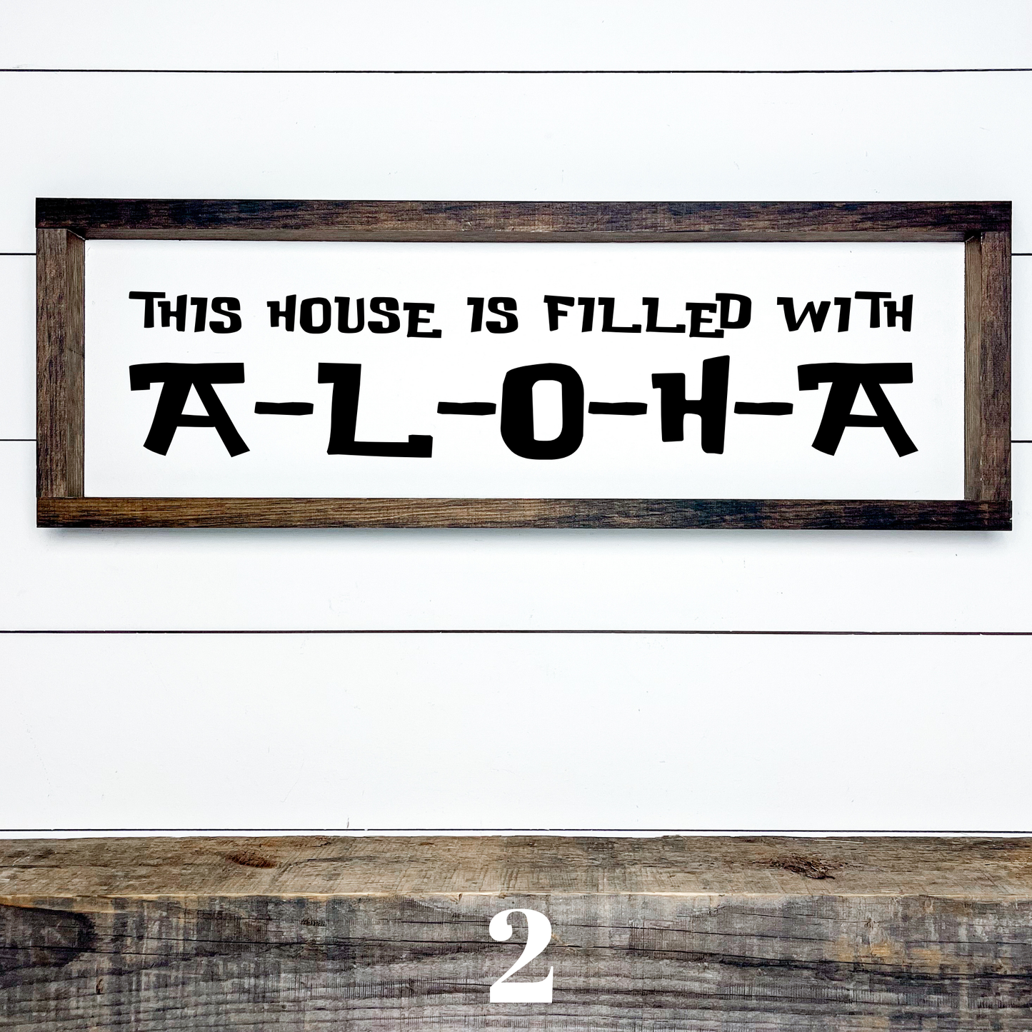 Horizontal wood sign with text "This House is Filled with Aloha" in multiple font styles, handcrafted by Simply Aloha On The Go.