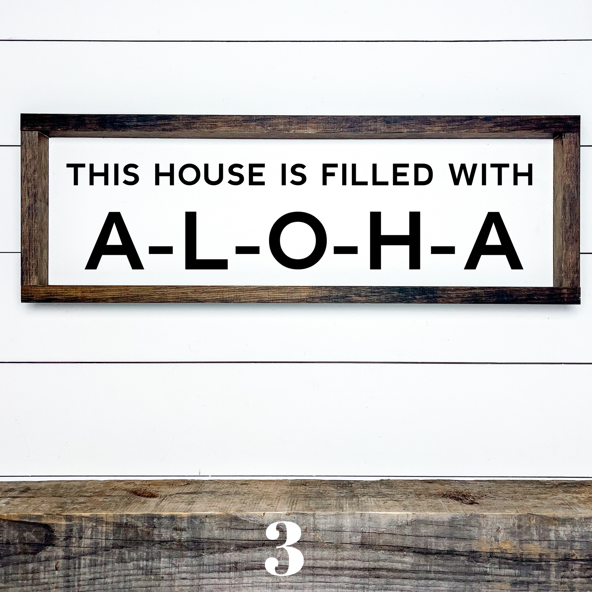 Horizontal wood sign with text "This House is Filled with Aloha" in multiple font styles, handcrafted by Simply Aloha On The Go.