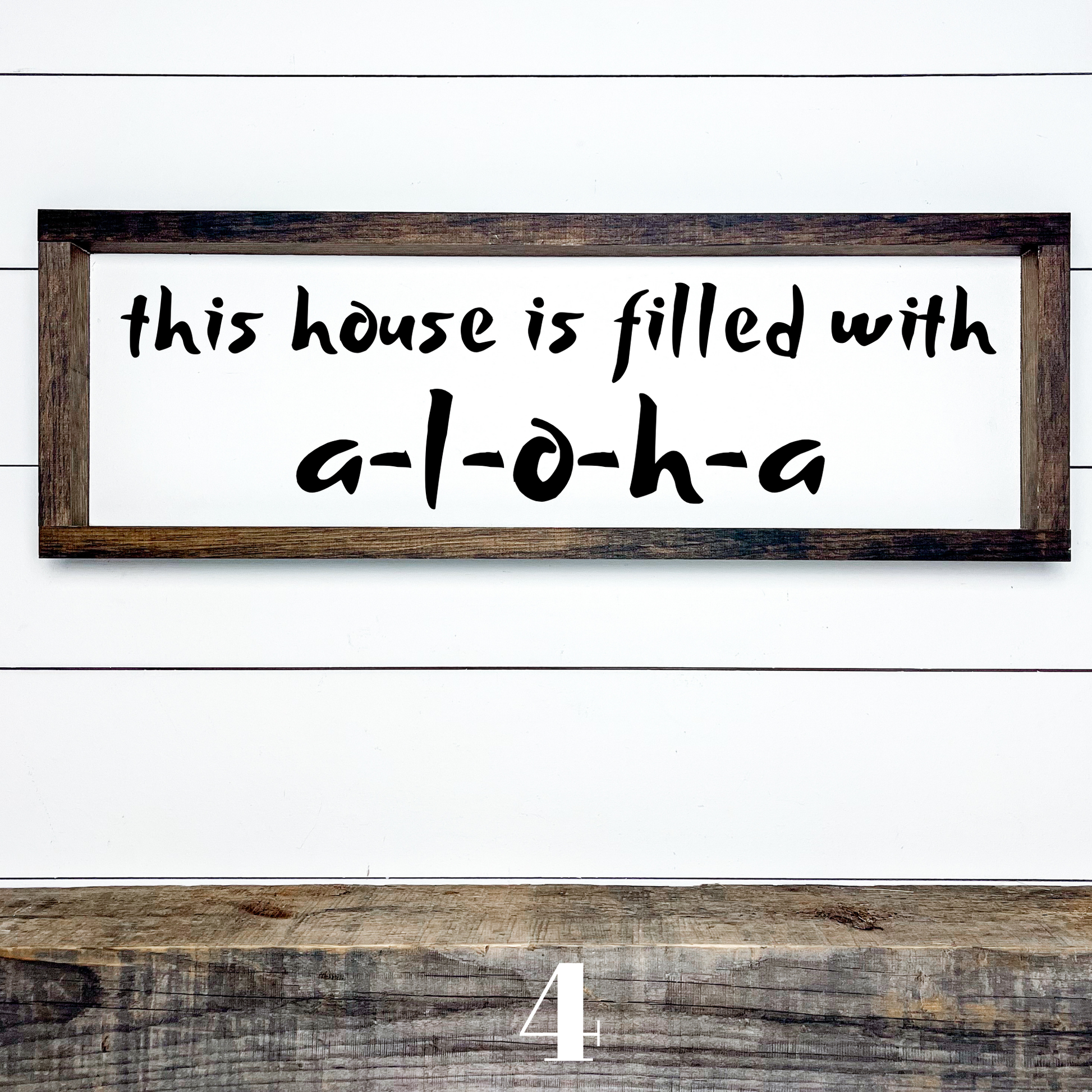Horizontal wood sign with text "This House is Filled with Aloha" in multiple font styles, handcrafted by Simply Aloha On The Go.