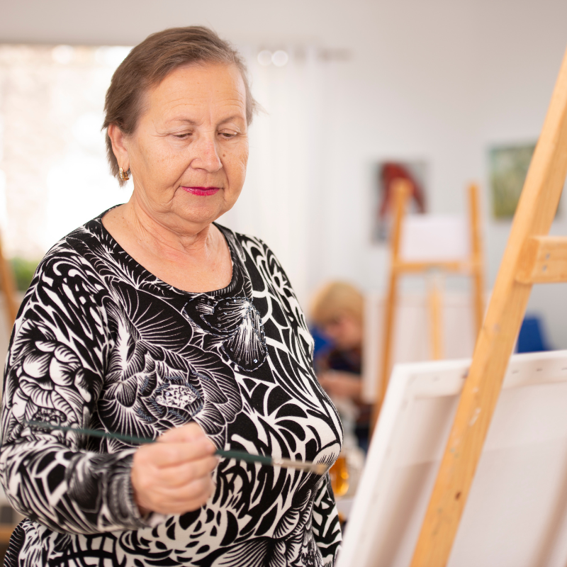 Grandma enjoying painting with her women's group paint party event 