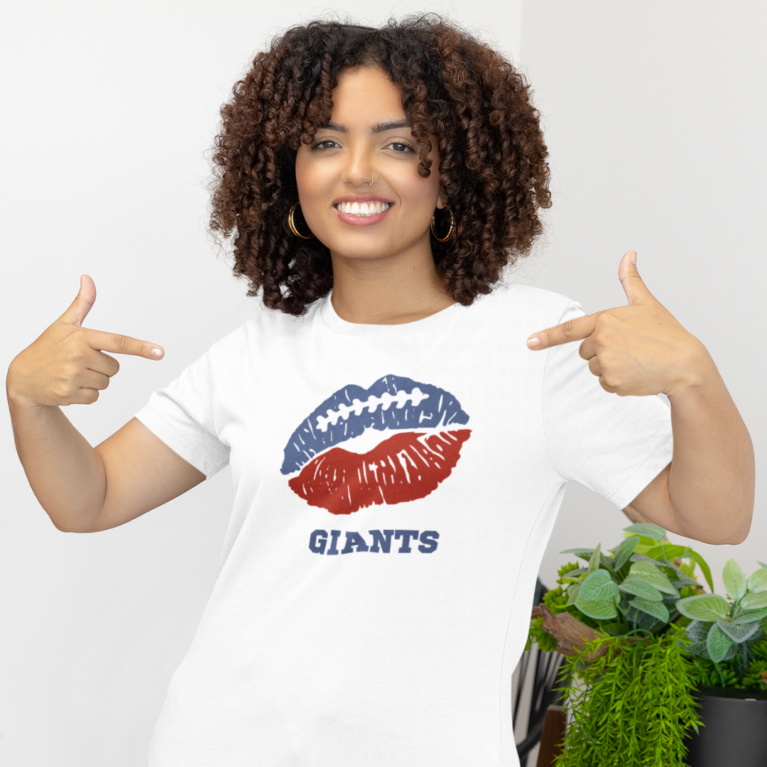A woman wearing a white t-shirt with a lip-themed football design reading Giants