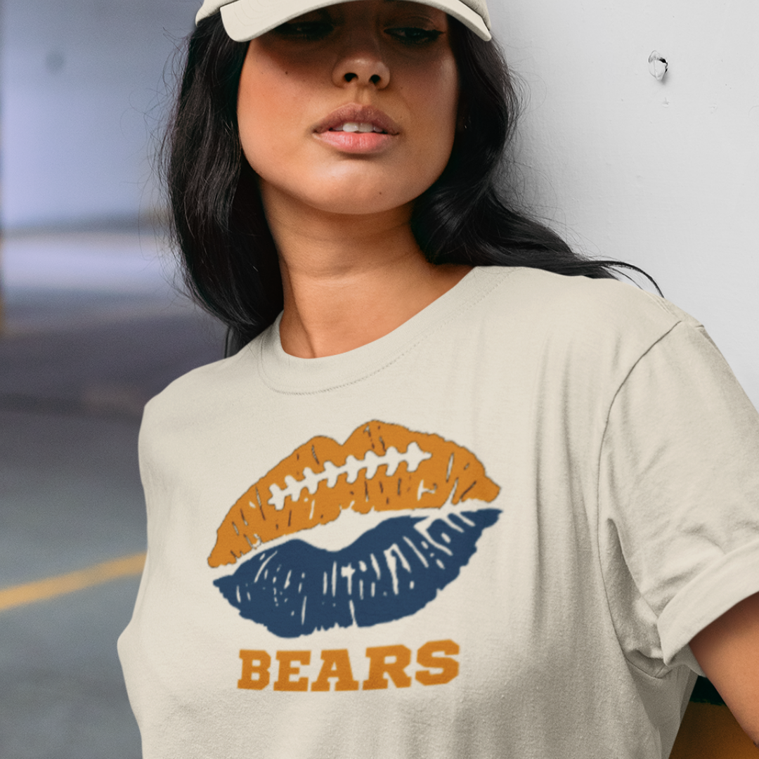 A woman wearing a cream t-shirt with a lip-themed football design reading Bears