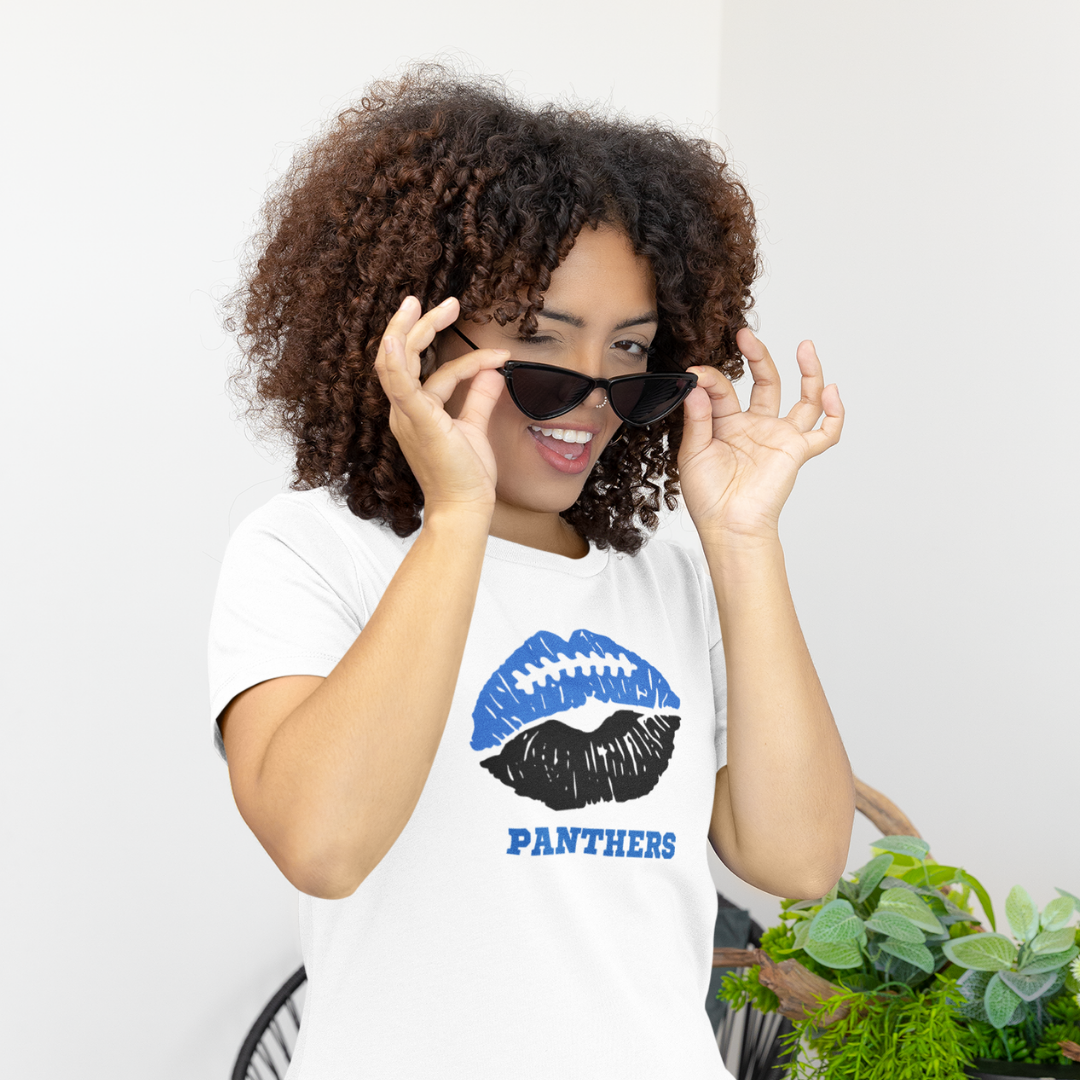 A woman wearing a white t-shirt with a blue and black lips football graphic and the word Panthers underneath