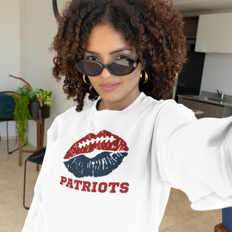 Custom white women's game day sweatshirt featuring a red and blue lip graphic with custom text "Patriots".
